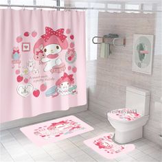 the bathroom is decorated in pink and has hello kitty shower curtains, rugs, and toilet paper