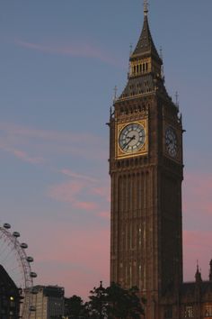 the big ben clock tower towering over the city of london, england at sunset or dawn