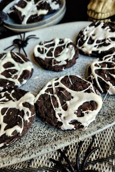 chocolate cookies with white icing on a plate