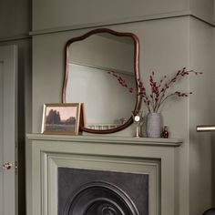 a fireplace with a mirror on top of it