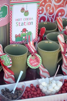 hot cocoa station with green cups and candy