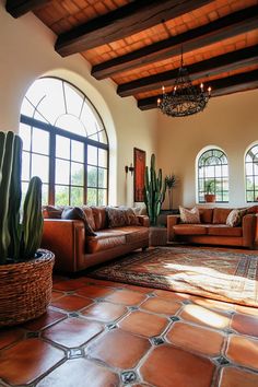 a living room filled with furniture and large windows