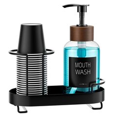 a soap dispenser with a bottle of mouthwash next to it on a tray