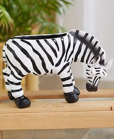 a zebra figurine sitting on top of a wooden table