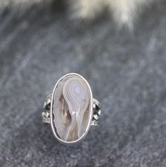 ♦Special Features: This ring features my not so wide bubble band and a beautiful Botswana agate. The band is full of texture and my granulation and a nice soft patina highlighting the textures. The stone is really something else. I admit to having a weakness for banded agates and this one has the most beautiful translucency to the banding. You can see how ribbon like each layer is and sort of watch it go down into the stone. These are a delight to examine and the coloring is a perfectly neutral Artisan Rings With Agate And Natural Stones, Artisan Agate Rings With Natural Stones, Handmade Agate Rings In Nature-inspired Style, Handmade Agate Rings With Nature-inspired Style, Unique Oval Agate Rings, Artisan Agate Oval Ring, Botswana Agate, Shades Of Beige, It's Going Down