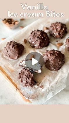 chocolate ice cream bites are sitting on a piece of parchment paper with the words vanilla ice cream bites