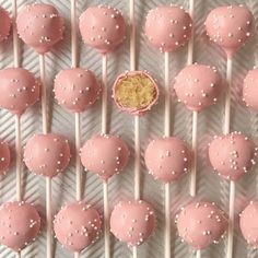 some pink cake pops with white sprinkles on them