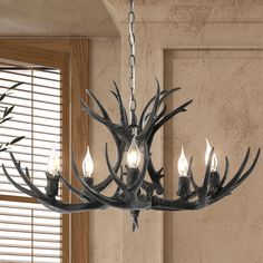 a chandelier with antlers hanging from it's sides in a room