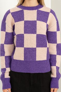 a woman wearing a purple and white checkered sweater