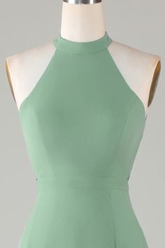 the back of a green dress on a mannequin headdress, with an open neckline