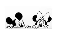 two mickey mouses sitting next to each other on top of a white surface with black and