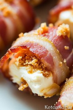 bacon wrapped in cheese and crumbs on a plate