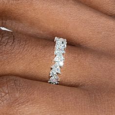 a woman's hand with a diamond ring on it