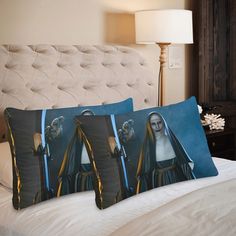 two pillow cases on top of a bed with the image of mary magdalene in blue