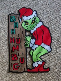 the grinch is holding a sign that says, santa's hug up on it