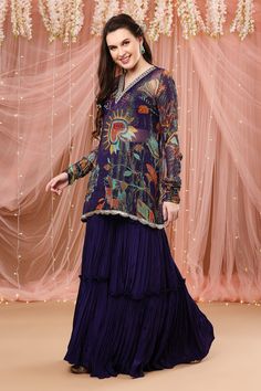 Purple floral print sheer kurta with zardozi embroidered detail. Paired with solid gharara and dupatta.
Component: 3
Pattern: Embroidered, Printed
Type Of Work: Zardozi work, Floral print
Neckline: V neck
Sleeve Type: Full sleeves
Fabric: Crepe silk, Chiffon, Organza
Color: Purple 
Other Details: 
Scallop hem kurta
Churidar sleeves
Note: Crop top worn by the model is not for sale
Occasion: Reception - Aza Fashions Sheer Kurta, Churidar Sleeves, Zardozi Work, Wear Crop Top, Scallop Hem, Churidar, Full Sleeves, Embroidered Silk, Silk Chiffon