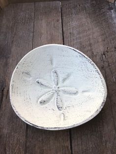 a white bowl sitting on top of a wooden table