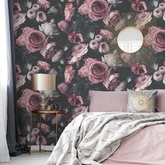 a bedroom with floral wallpaper and a round mirror on the wall above the bed