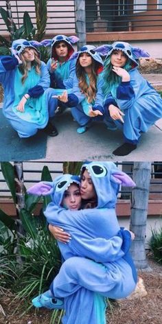 two women dressed in costumes and one is hugging