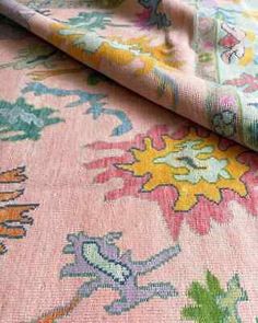 a pink and green floral print fabric with an intricate design on the bottom half of it