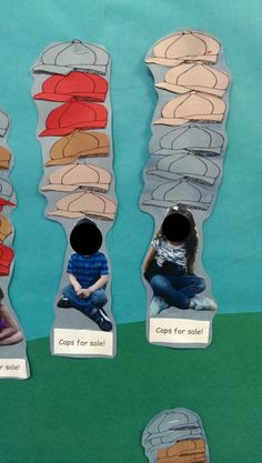 three children are sitting on the ground in front of paper cutouts with different shapes and sizes