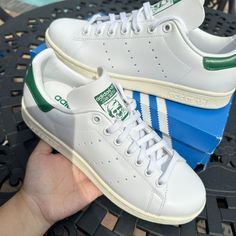 Description How Should You Describe A Shoe That Is As Iconic As The Adidas Stan Smith In Its Og White And Green Colorway? Constructed With A Leather Upper With 3-Stripe Perforations And Debossed Adidas Trefoil Branding On The Heel And Stan Smit Logo On The Tongue. There Is Not Much More To Say. This Is The Number 1 Go-To Sneaker For So Many Of Us. - Full Grain Leather Upper - Perforated 3-Stripes - Stan Smith Logo On Tongue - Comfortable Leather Lining - Ortholite Sockliner - Logo On Heel Tab - Things I Need To Buy, Men's Athletic Shoes, Men's Outfits, Mens Athletic Shoes, Adidas Trefoil, The Number 1, Green Man, White Adidas, Number 1