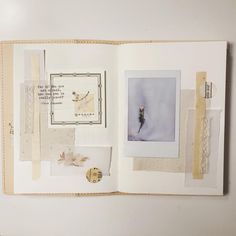 an open book with pictures and papers on the pages, including buttons and laces