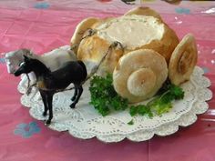 there is a small horse on a plate with bread