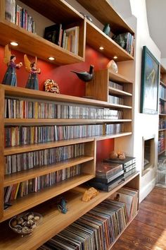 there are many bookshelves in the room with dvds on them and other items