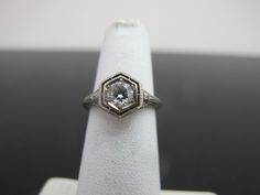 a diamond ring sitting on top of a white napkin