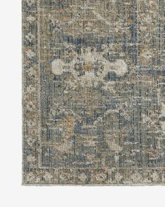 an area rug with various colors and patterns on the carpet, including blue, gray, beige