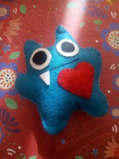 a blue stuffed animal with a red heart