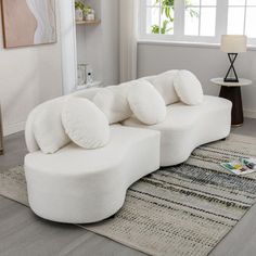 a large white couch sitting on top of a rug