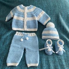 a crocheted baby outfit and booties on a bed