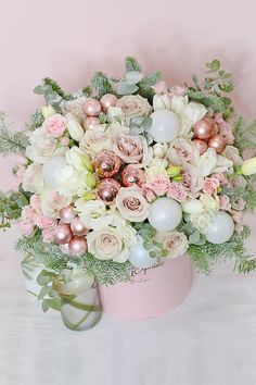 An endearing Christmas floral arrangement evoking sweetness, affection, and everything to love during the holidays. This chic floral design features a spectacular display of creamy white tulips, quicksand roses, and lisianthus paired with blush pink spray roses resting on a bed of fresh pine tree and eucalyptus. Decorated with shiny white and sparkly pink ball ornaments, it comes in a stylish pink hatbox, which doubles as a keepsake once the flowers have faded. Pink Winter Floral Arrangements, Pink Christmas Floral Arrangements, Pink Christmas Tablescapes, Merry Pinkmas, Flowers For Christmas, Holiday Flower Arrangements, Pink Spray Roses, Xmas Flowers, Christmas Floral Designs