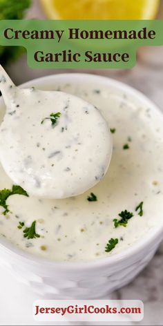 a spoon full of creamy homemade garlic sauce