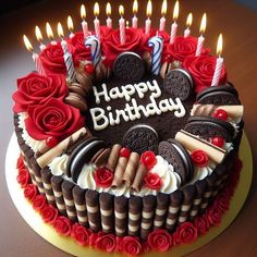 a birthday cake with red roses and chocolate cookies