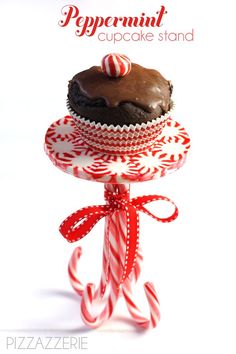 a chocolate cupcake on top of a candy cane