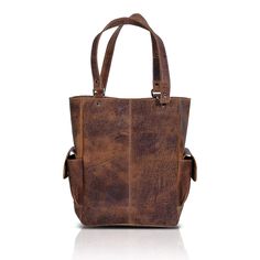 FULL GRAIN LEATHER- Each of our bags is handcrafted by experienced craftsmen and is made from full-grain water buffalo leather. The leather is thick and sturdy yet not rigid. SPACIOUS INTERIORS - Lined with high-end canvas the bag measures 14 inches high 11 inches wide 6 inches deep. This tote bag can fit a small laptop or Tablet With all your daily essentials. The bag also has a small magnetic closure strap. STORAGE - The bag has 1 interior zipper pocket, cellphone and pen pocket inside and has Rustic Brown Bags With Leather Handles, Rustic Brown Travel Bag, Vintage Brown Leather Tote Satchel, Rugged Vintage Brown Bag For Daily Use, Rugged Vintage Brown Leather Bag, Rustic Brown Bag With Waxed Finish, Brown Textured Vegetable Tanned Leather Bags, Distressed Brown Oiled Leather Bag With Waxed Finish, Rugged Satchel Shoulder Bag With Leather Backing