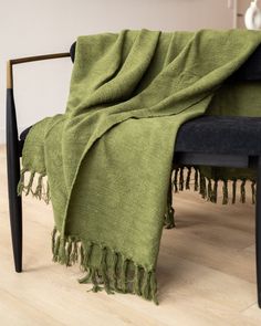 a chair with a green blanket on top of it