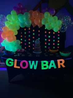 glow bar set up with balloons and cake