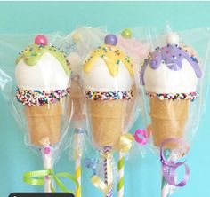 three ice cream cones with sprinkles and bows on them are wrapped in plastic