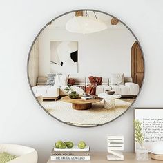 a living room filled with furniture and a round mirror