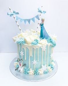 a frozen princess cake with frosting and decorations