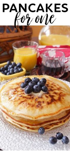 pancakes with blueberries and orange juice on the side