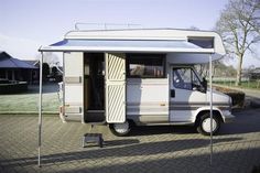 an rv is parked in the driveway with its door open