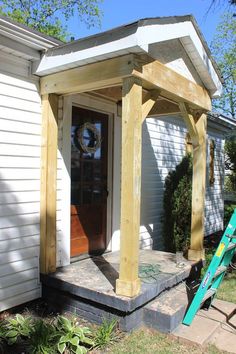 a house with a front porch covered in wood