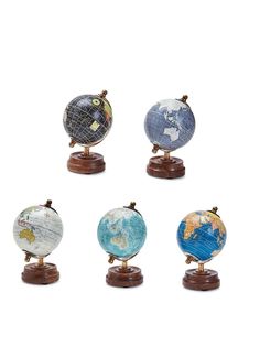 four small globes sitting on top of each other in front of a white background