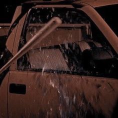 a man is cleaning the windshield of a car