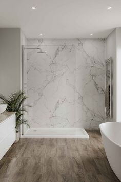 a large bathroom with marble walls and flooring, along with a bathtub in the middle